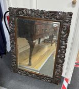 An early 20th century carved oak rectangular wall mirror, width 68cm, height 86cm