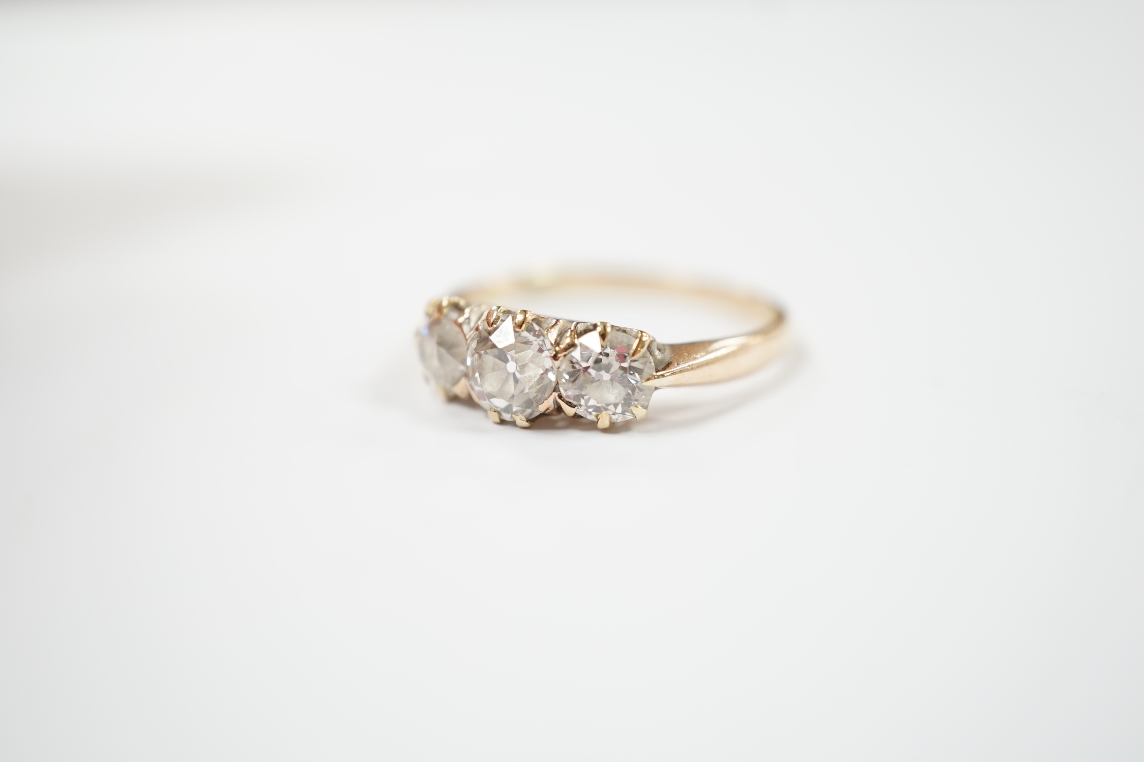 A yellow metal and three stone diamond set ring, size P, gross weight 2.6 grams. - Image 2 of 4