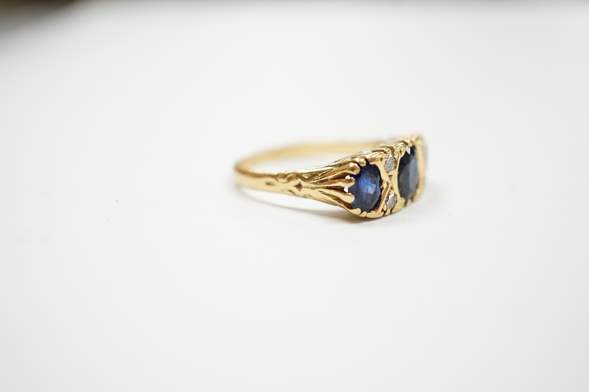 An 18ct and three stone sapphire set half hoop ring, with diamond chip spacers, size O, gross weight - Image 3 of 4