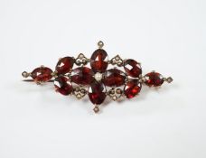 A Victorian yellow metal, garnet and seed pearl cluster set brooch, 44mm, gross weight 4.8 grams.