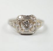 A mid 20th century engraved white metal and single stone diamond set ring, the pierced setting set