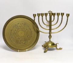 Two pieces of Judaica comprising brass Chanukka and circular dish, largest 31cm high
