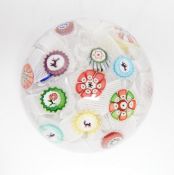 A Baccarat glass paperweight with scattered silhouette and other canes on a quilted latticino