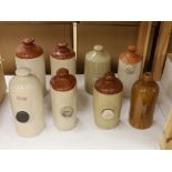 Eight various stoneware hotwater bottles, early 20th century, largest 30cm high
