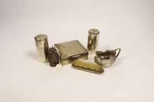 A late Victorian embossed silver cream jug, a pair of silver toilet bottles, a silver backed