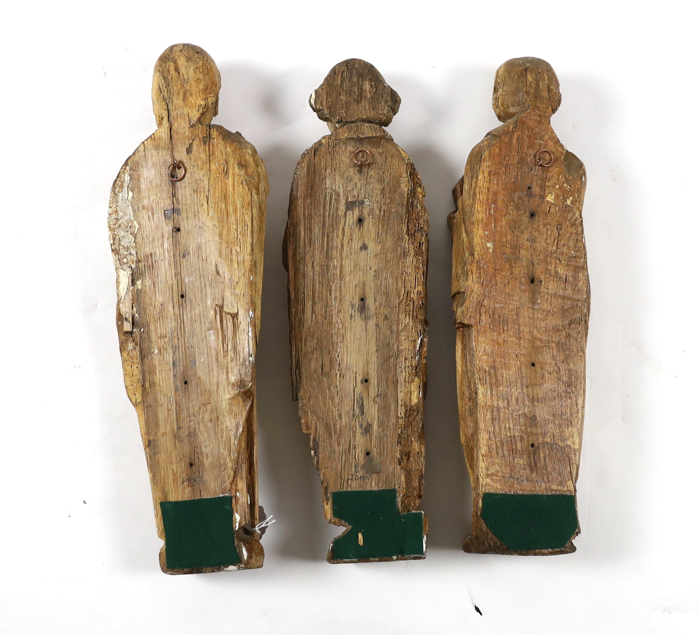 A set of three 18th century Continental carved wood figures of Saints, holding a cross, a bible - Image 3 of 3