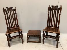 A pair of 17th century style carved oak chairs and a small stool