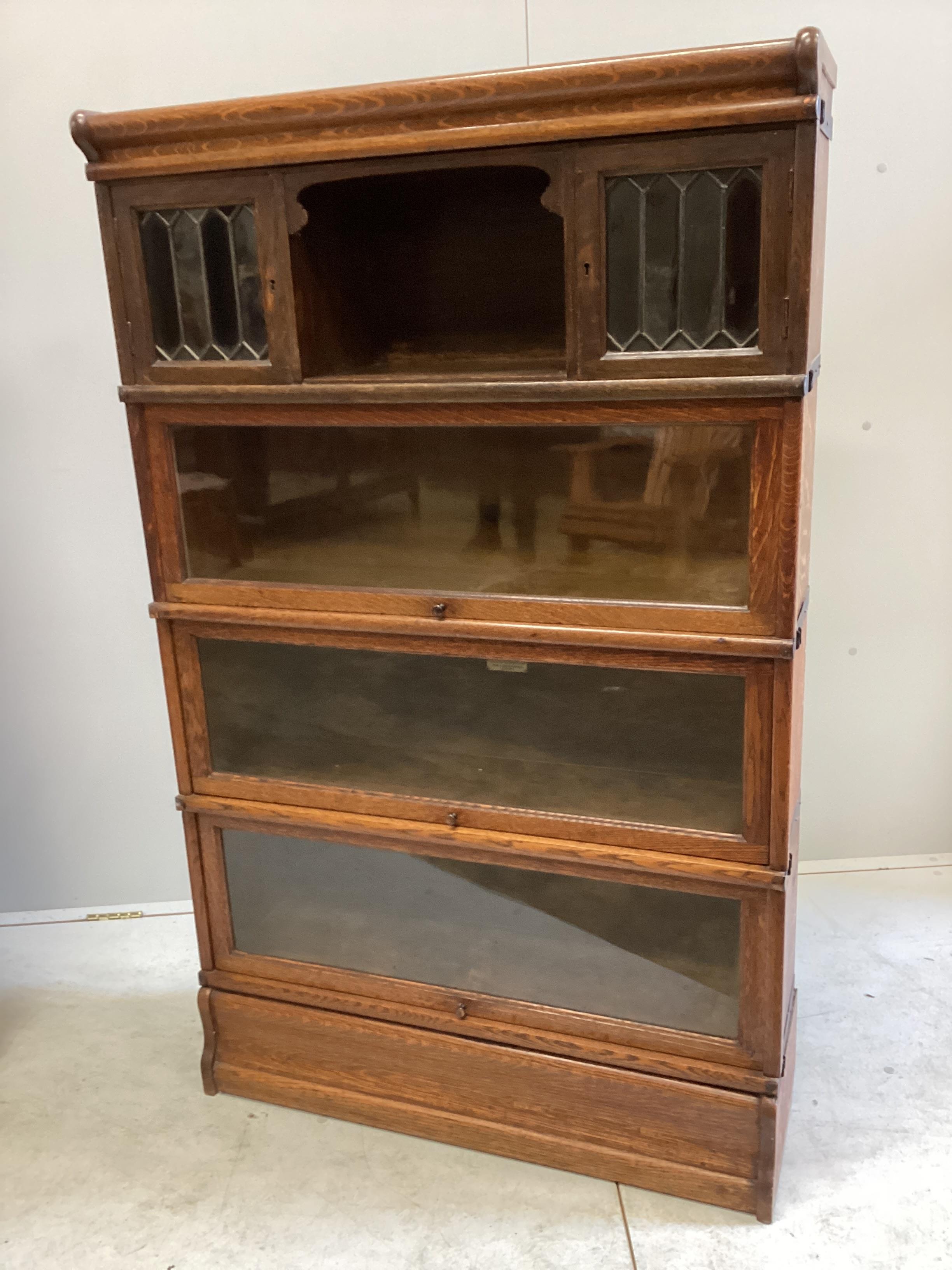 A Globe Wernicke oak four section bookcase, width 86cm, depth 27cm, height 140cm