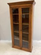 An early 20th century oak and mahogany narrow bookcase with later plinth foot, width 78cm, depth