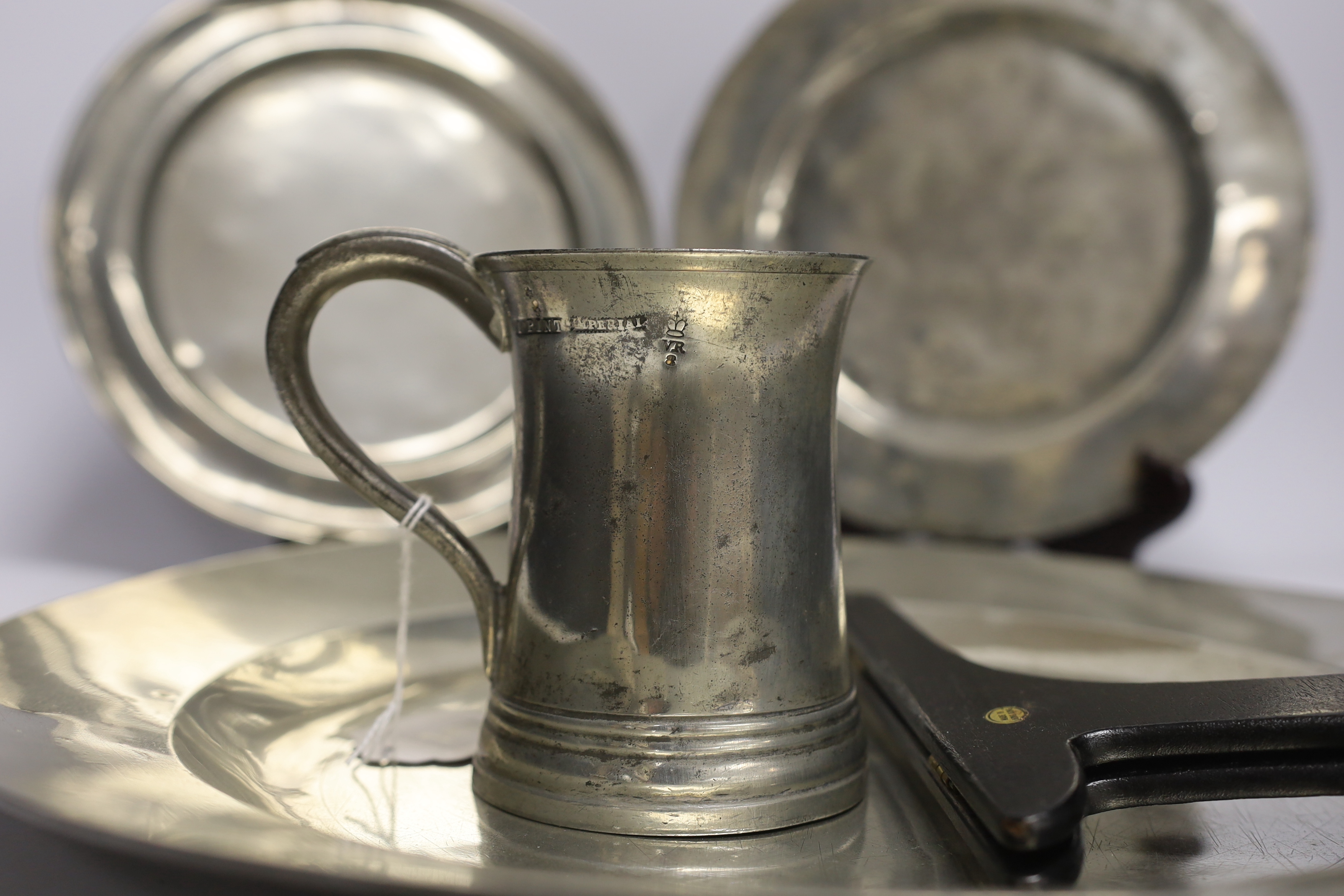 Four 18th century and later pewterware items including a charger, 41.5cm diameter, two plates, and a - Image 2 of 4