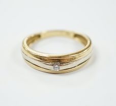 A two colour 750 yellow metal and single stone diamond chip set ring, size L, gross weight 3.3