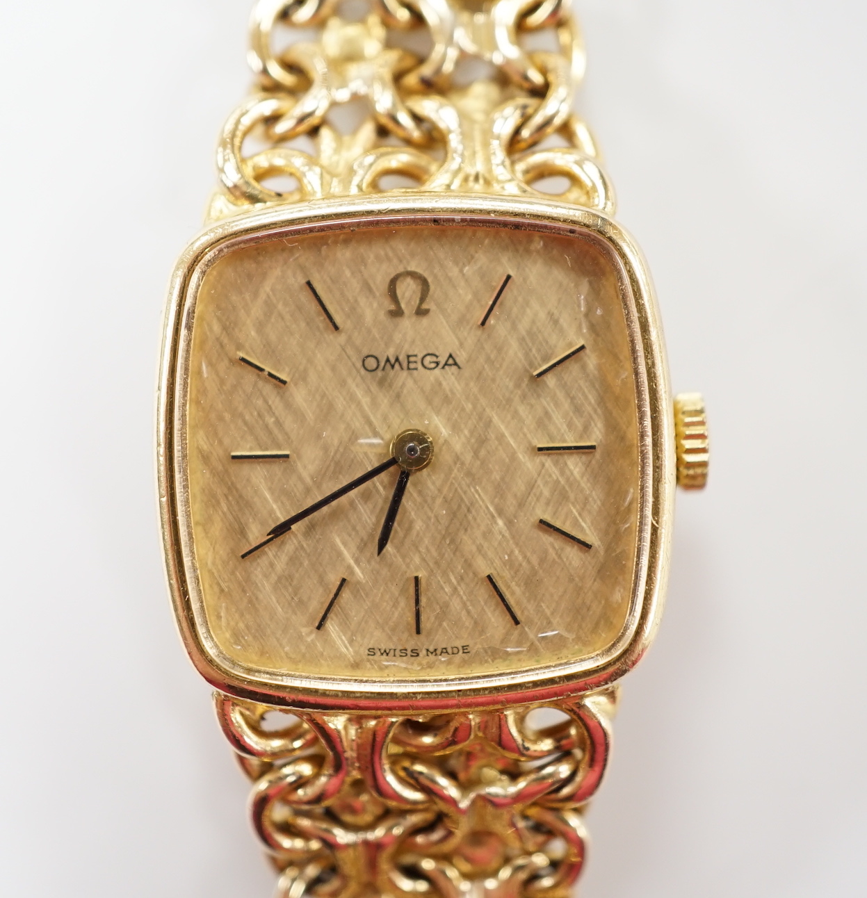 A lady's 1970's 9ct gold Omega manual wind wrist watch, on integral Omega 9ct gold bracelet,