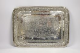 A Persian? engraved white metal tea tray, with embossed foliate border, 42cm, 46.4oz.