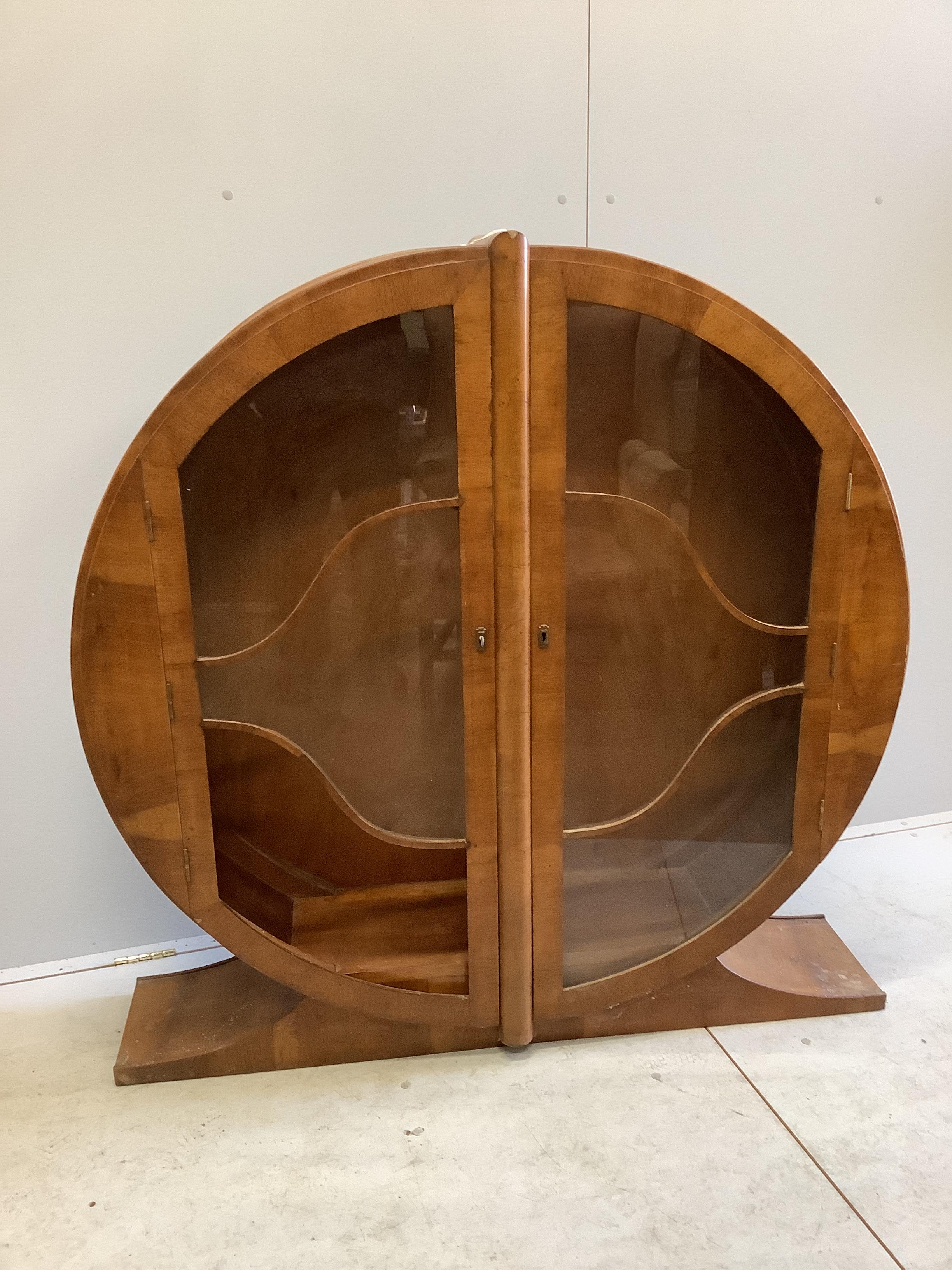 An Art Deco circular walnut veneered display cabinet, width 126cm, depth 30cm, height 125cm