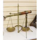 A telescope on tripod stand and a Doyle brass balance, largest 55cm high