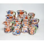 Eleven graduated Masons ironstone jugs, largest 13cm high