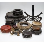 Assorted Chinese wooden and metal stands, largest 25cm in diameter