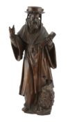 A 19th century carved elm figure of St. Jerome reading from the bible with a lion at his feet,