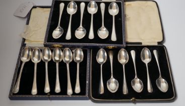 Three assorted cased sets of six silver tea or coffee spoons including Old English feather edge