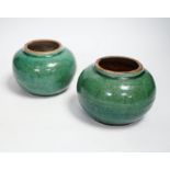 A pair of Chinese pottery monochrome green glazed jars, 10cm high