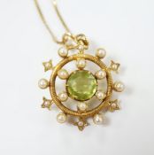 An Edwardian yellow metal, peridot and seed pearl cluster set 'wheel' pendant, overall 30mm, on a