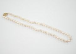 A single strand cultured pearl necklace with 18K and diamond chip set spherical clasp, 49cm.