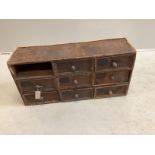 A painted pine nest of eight drawers, width 78cm, depth 22cm, height 38cm