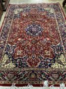A Tabriz style burgundy ground rug, 224 x 155cm