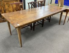 A 19th century rectangular Provincial oak kitchen table with cleated plank top, fitted two drawers