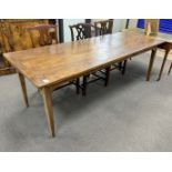 A 19th century rectangular Provincial oak kitchen table with cleated plank top, fitted two drawers