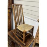 An early 20th century beech rush seat rocking chair, width 40cm, depth 67cm, height 89cm