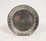 A George III Irish silver small dish, with repousse border and engraved crest, by Matthew West,