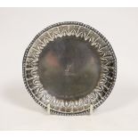 A George III Irish silver small dish, with repousse border and engraved crest, by Matthew West,