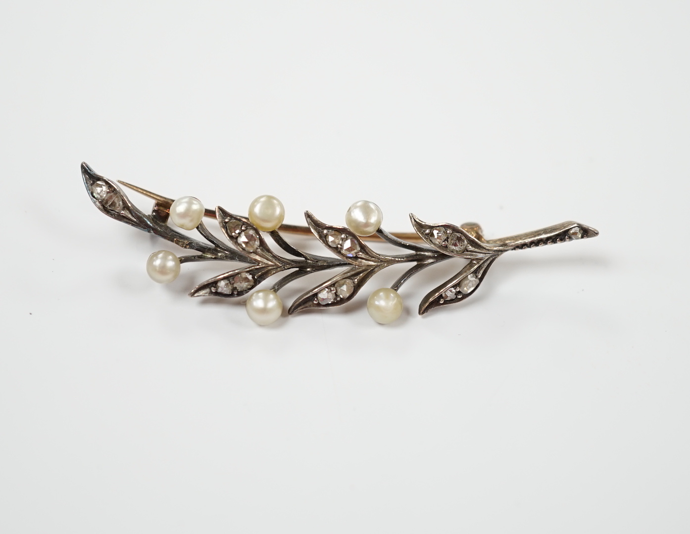 An early 20th century yellow metal, cultured pearl and rose cut diamond set foliate spray brooch,