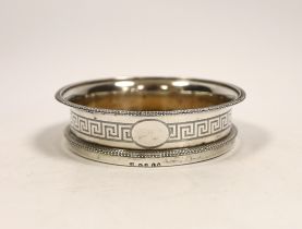 A George III silver mounted wine coaster, with gadrooned border and engraved Greek Key decoration,