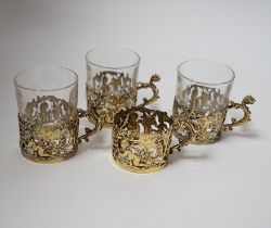 A set of four late Victorian pierced silver gilt coffee can holders, by William Comyns,