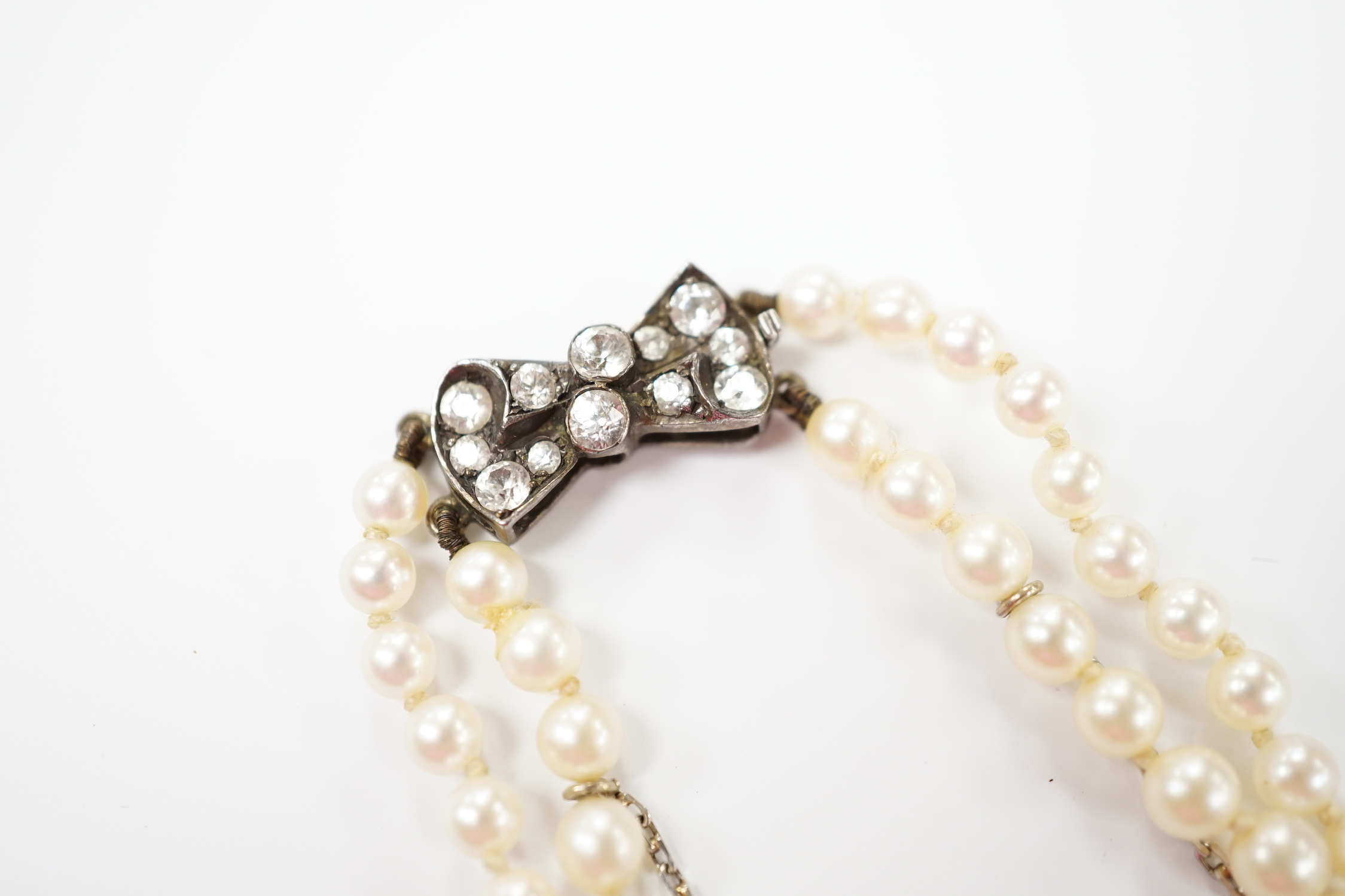 A double strand graduated cultured pearl necklace, with paste set white metal clasp, 44cm. - Image 3 of 4