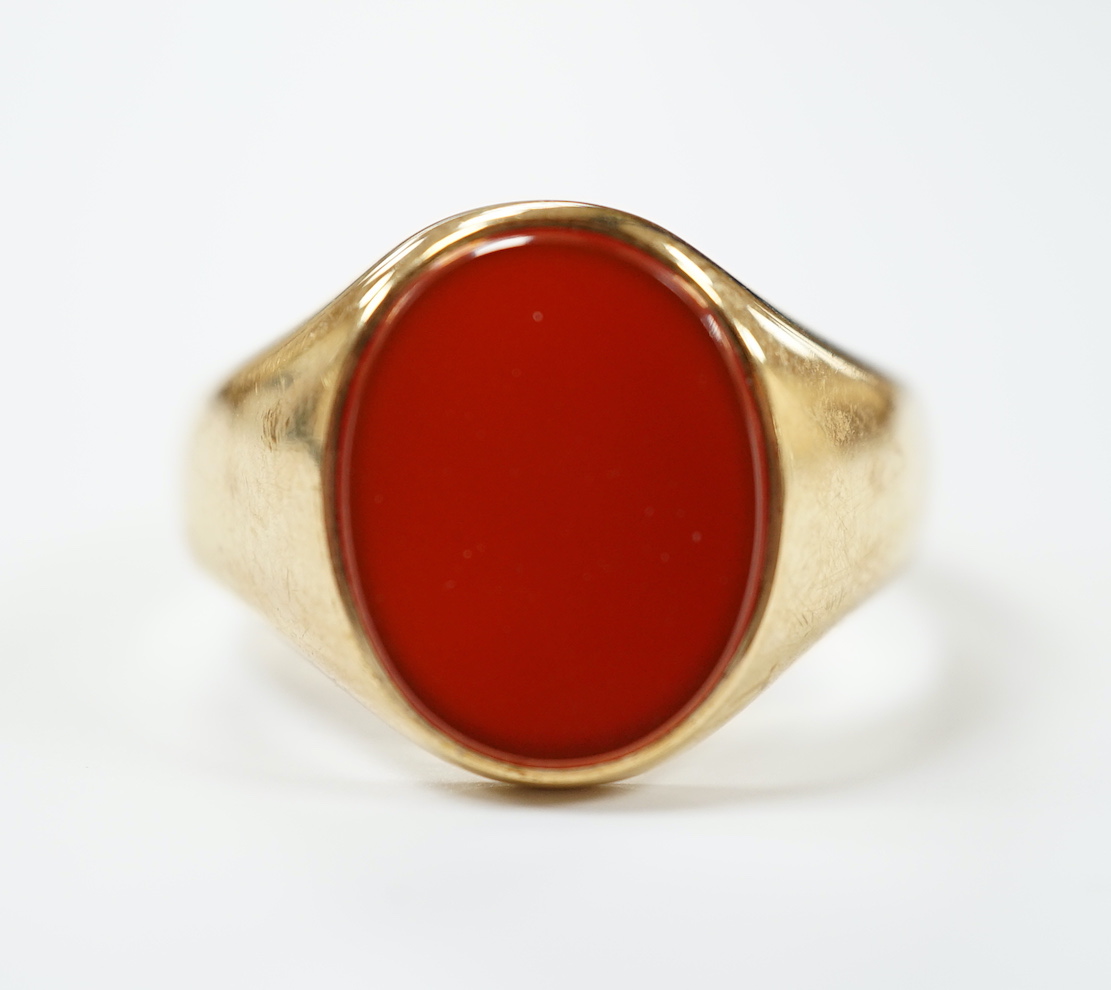 A 9ct gold and single stone oval carnelian set signet ring, size W, gross weight 8.7 grams.