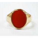 A 9ct gold and single stone oval carnelian set signet ring, size W, gross weight 8.7 grams.