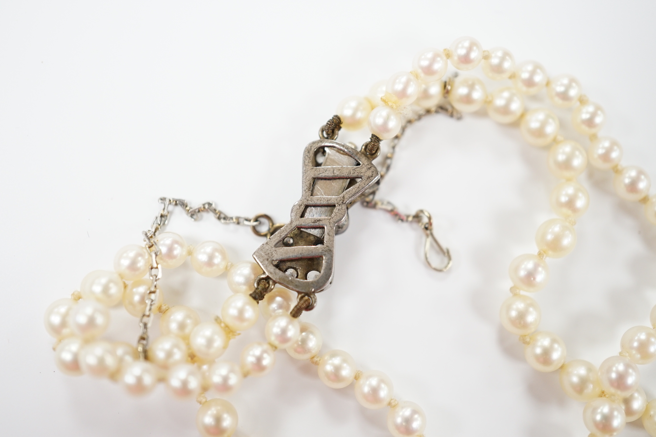 A double strand graduated cultured pearl necklace, with paste set white metal clasp, 44cm. - Image 4 of 4