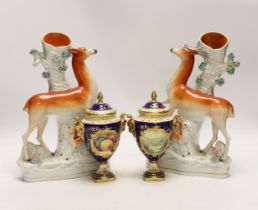 A pair of Coalport vases and covers and a pair of Staffordshire deer spill vases, largest 29cm high