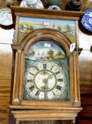 An oak cased Dutch wall clock with arched painted dial, case inset painted landscape panels,
