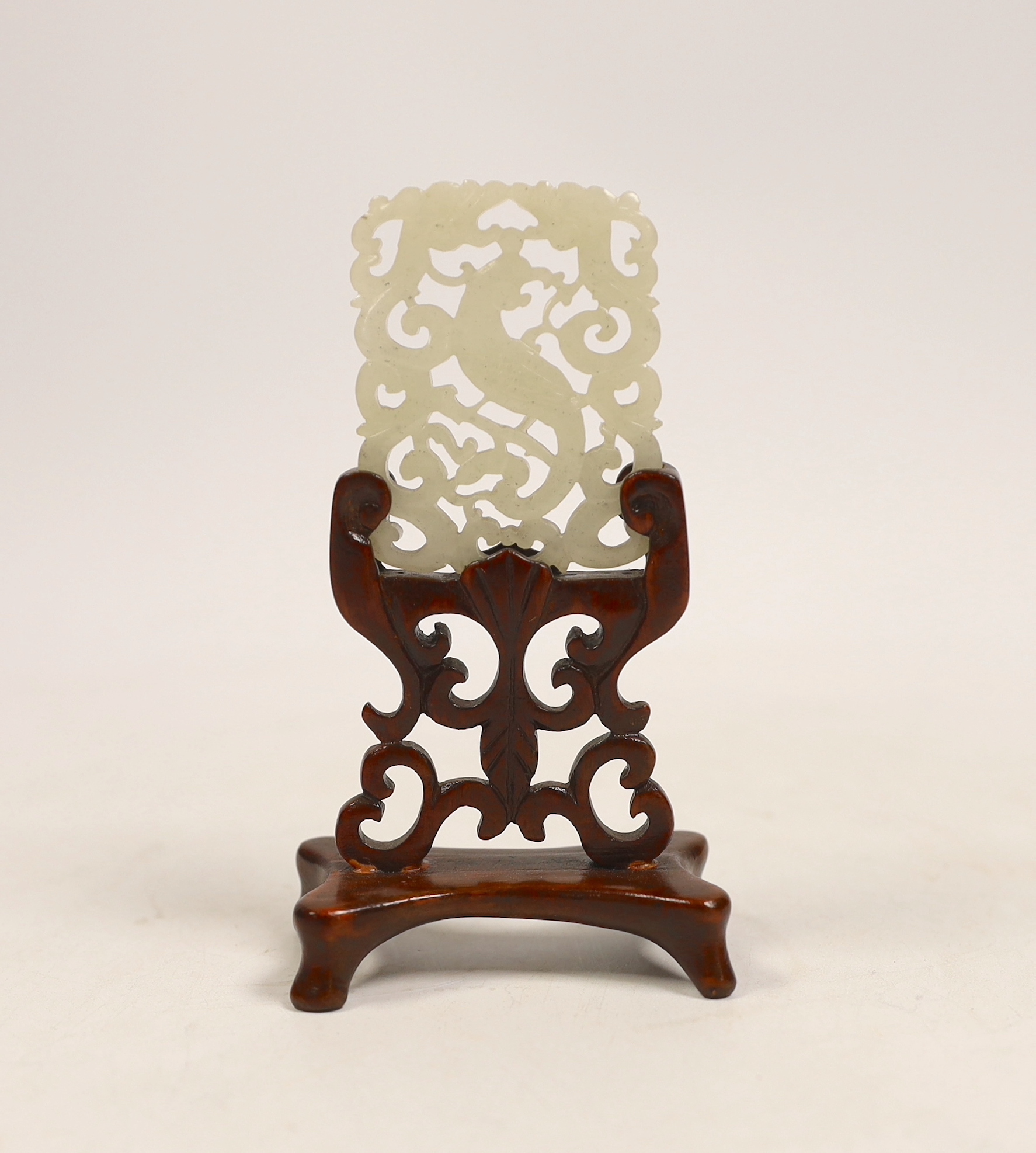 A Chinese jade ‘phoenix’ plaque, late 19th/early 20th century, 5.5 x 4.4cm on hardwood stand,