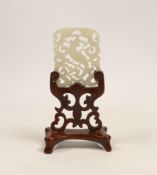 A Chinese jade ‘phoenix’ plaque, late 19th/early 20th century, 5.5 x 4.4cm on hardwood stand,