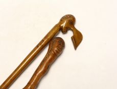 Two walking canes including a Greek olive wood example with carved head handle, largest 89cm in