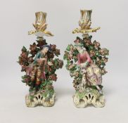 A pair of Chelsea figural candlesticks, c.1765, 30cm