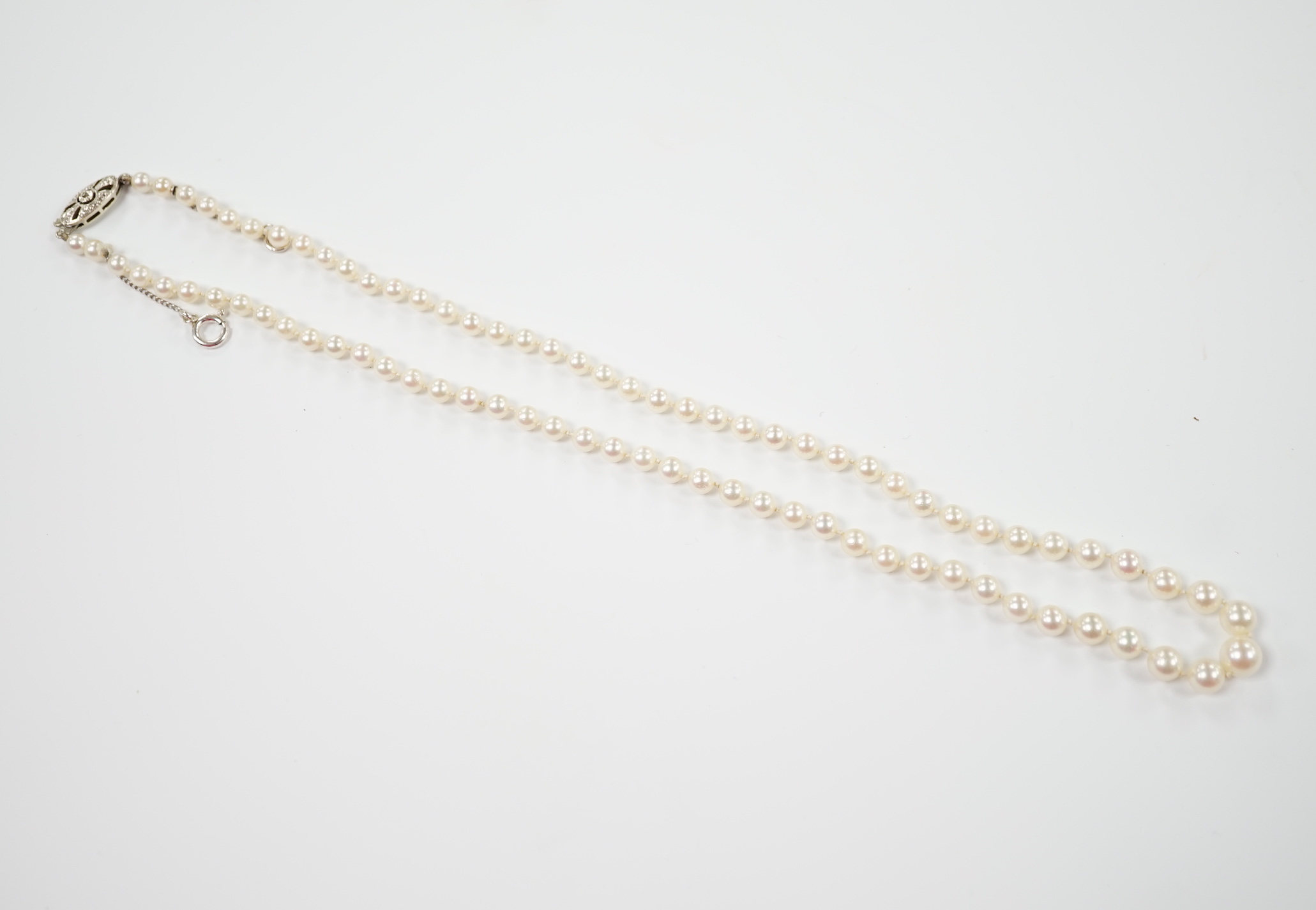 A single strand graduated cultured pearl necklace, with single stone diamond chip set 9ct white