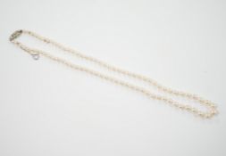 A single strand graduated cultured pearl necklace, with single stone diamond chip set 9ct white