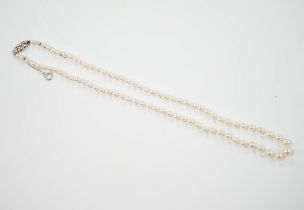 A single strand graduated cultured pearl necklace, with single stone diamond chip set 9ct white