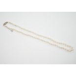 A single strand graduated cultured pearl necklace, with single stone diamond chip set 9ct white